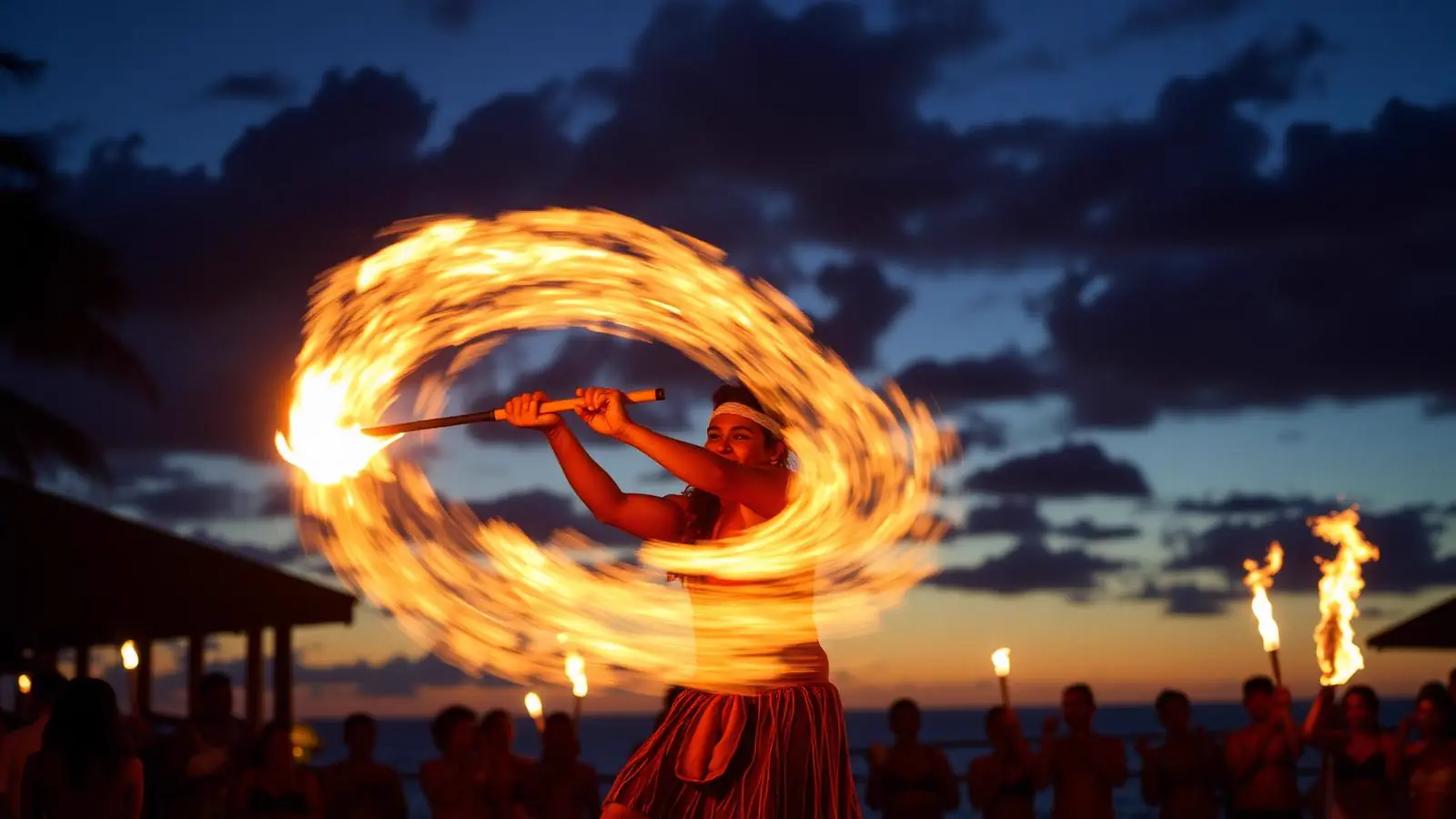 Polynesian fire-knife dancer performing at dusk during a Maui luau show, representing the island's luau companies and venues