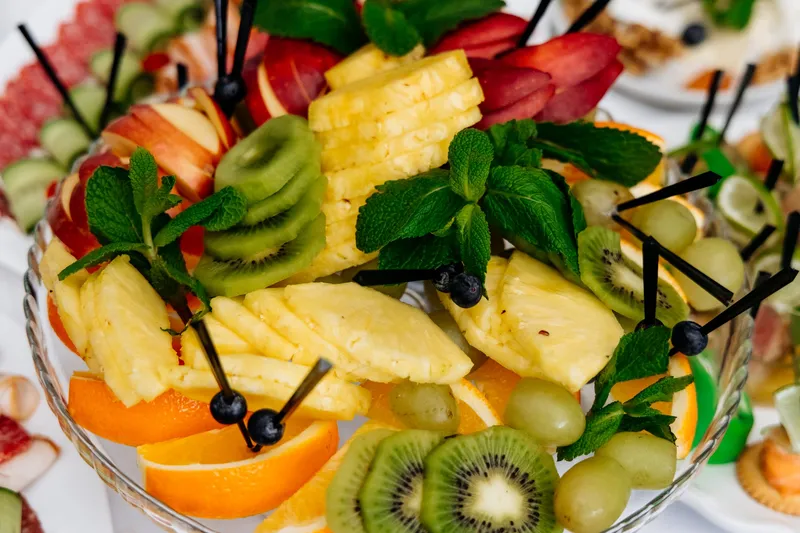 Platter of fresh pineapple, kiwi, oranges and grapes