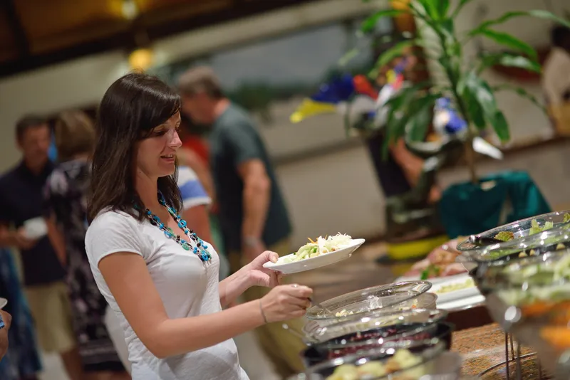 Guest serving herself from a resort dinner buffet